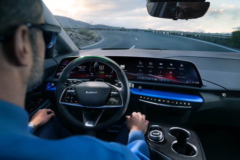 Front View of the 2026 OPTIQ-V Driving Through the Dusk Utilizing its Headlights | Dan Vaden Cadillac Brunswick in Brunswick GA